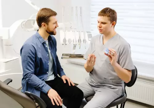 A dentist discussing the results of Oral Cancer Screenings in Peoria IL