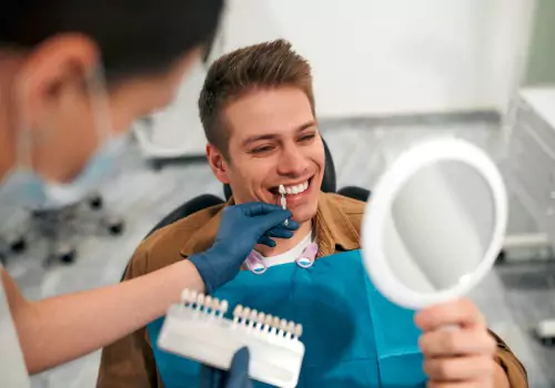 A dentist showing a patient how effective their Teeth Whitening procedure was