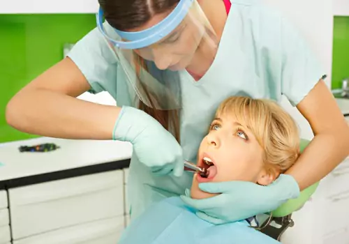 A dentist performing tooth extraction, part of Oral Surgery services in Peoria IL