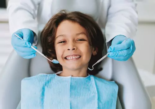 A happy child having their teeth looked at by a Pediatric Dentist for East Peoria IL