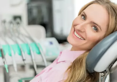 A woman is seen at a dental visit. The Smile Center offers teeth whitening in Peoria IL.