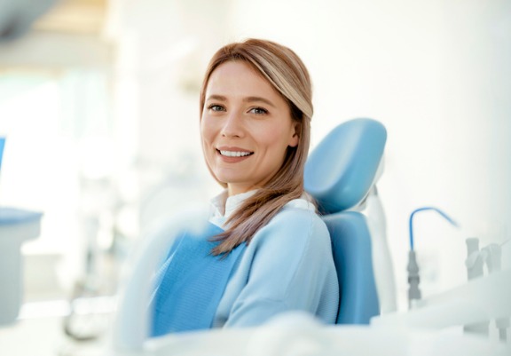 A woman smiles after visiting The Smile Center, which offers general dentistry in Peoria IL