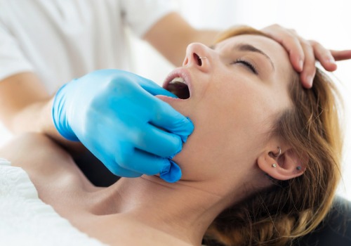 Dentist performing oral muscle exercises as part of myofunctional therapy in Peoria IL