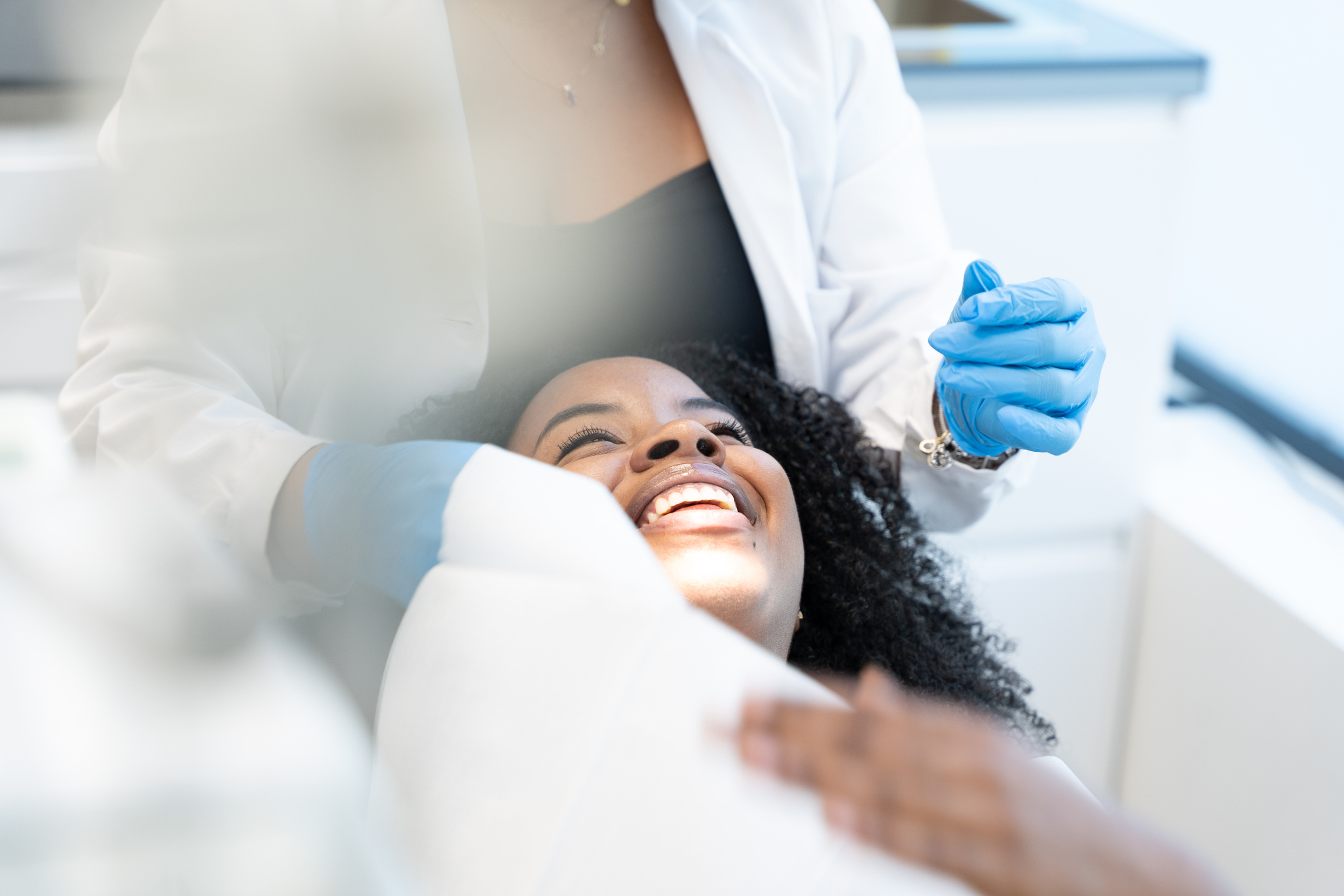 A happy woman from Dunlap IL smiles while getting her teeth checked out at The Smile Center
